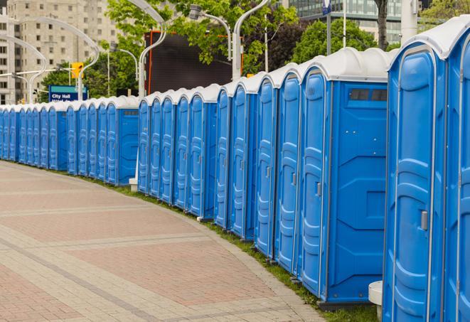 a row of portable restrooms set up for a large athletic event, allowing participants and spectators to easily take care of their needs in Kennesaw